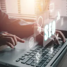Hand zeigt auf Touchscreen mit digitalen Symbolen – innovative Ansätze im Marketing & SEO.